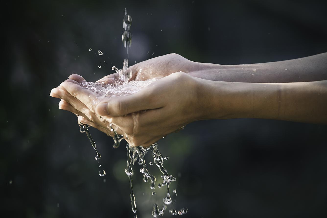 closeup water flow to hand of women for nature concept on the ga closeup water flow to hand of women for nature concept on the garden background.